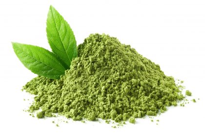 Heap of green tea leaves and powder Heap of green tea leaves and powder
