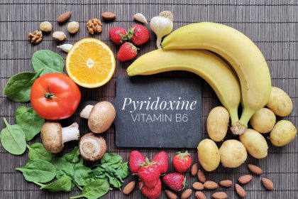 Foods rich in vitamin B6 (Pyridoxine). Assortment of fresh fruit and vegetable high in vitamin B6. Natural sources of vitamin B6: banana, potato, mushroom, tomato, garlic, spinach, almond, strawberry. Foods rich in Vitamin B include spinach, kale bananas